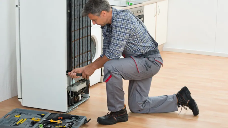 man-repairing-refrigerator